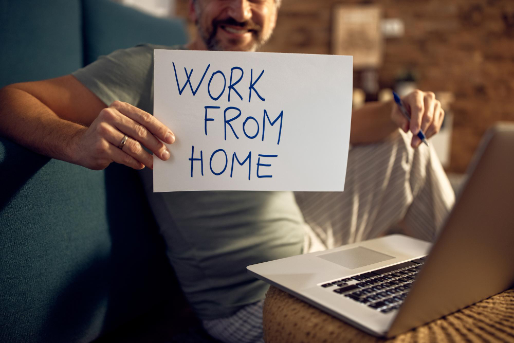 Employee working remotely with laptop in home office setup in Ireland